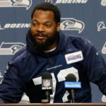 Michael Bennett sits during anthem, plans to protest all season