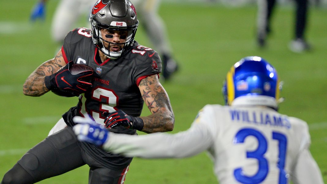 Tampa Bay Buccaneers wide receiver Mike Evans (13) gets around Los Angeles Rams defensive back Darious Williams (31) to score on a 9-yard touchdown reception from Tom Brady during the first half of an NFL football game Monday, Nov. 23, 2020, in Tampa, Fla. (AP Photo/Jason Behnken)