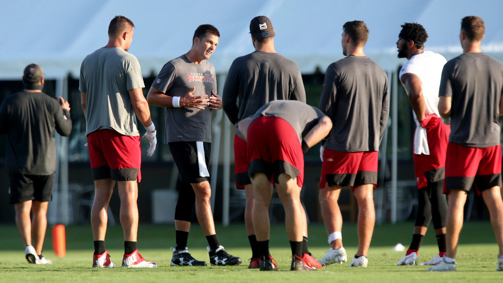 Tampa Bay Buccaneers quarterback Tom Brady, third from left, joins his teammates at midfield during NFL football training camp, Tuesday, Aug. 4, 2020, in Tampa. (Douglas R. Clifford/Tampa Bay Times via AP)