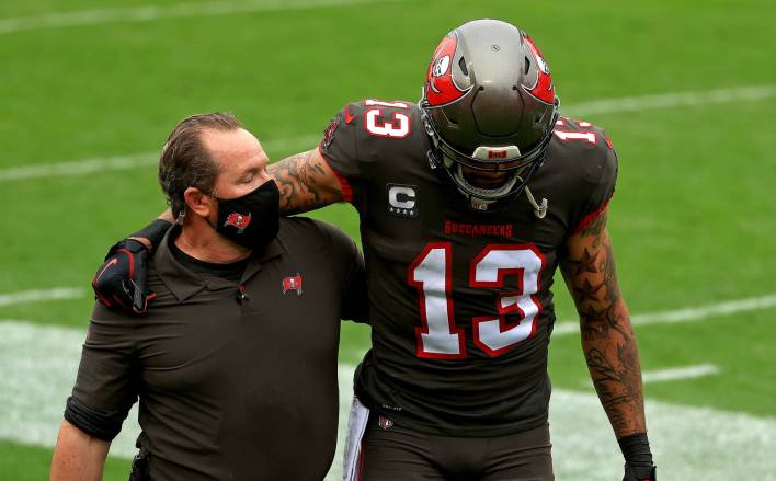 Buccaneers wide receiver Mike Evans is helped off the field versus the Falcons/ Mike Ehrmann / Getty Images