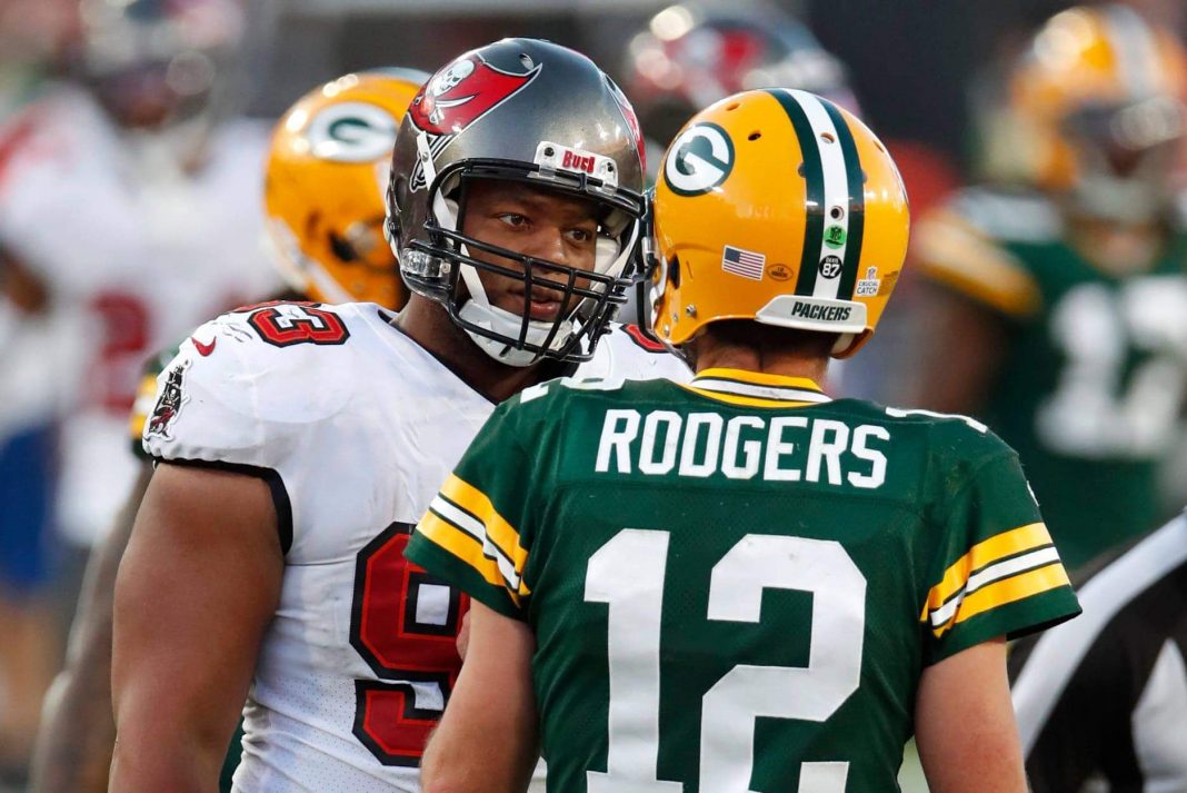 Tampa Bay Buccaneers defensive end Ndamukong Suh talks with Green Bay Packers quarterback Aaron Rodgers (12) during the second half of the Buccaneers' 38-10 win Sunday. (Jeff Haynes/AP Images for Panini)