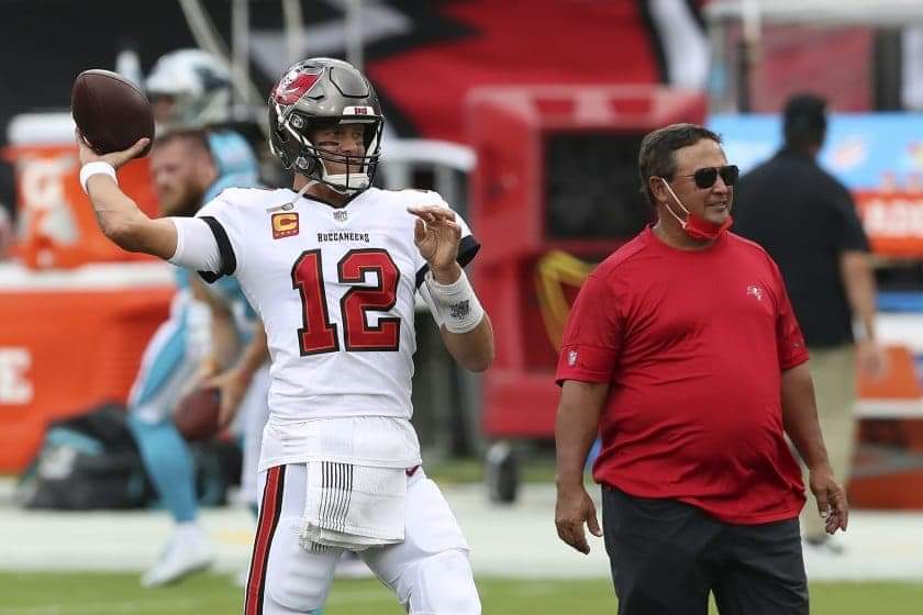 Tampa Bay Buccaneers’ Tom Brady throws a pass as quarterbacks coach Clyde Christensen looks on before a game against the Carolina Panthers on Sept. 20.(Mark LoMoglio / Associated Press)