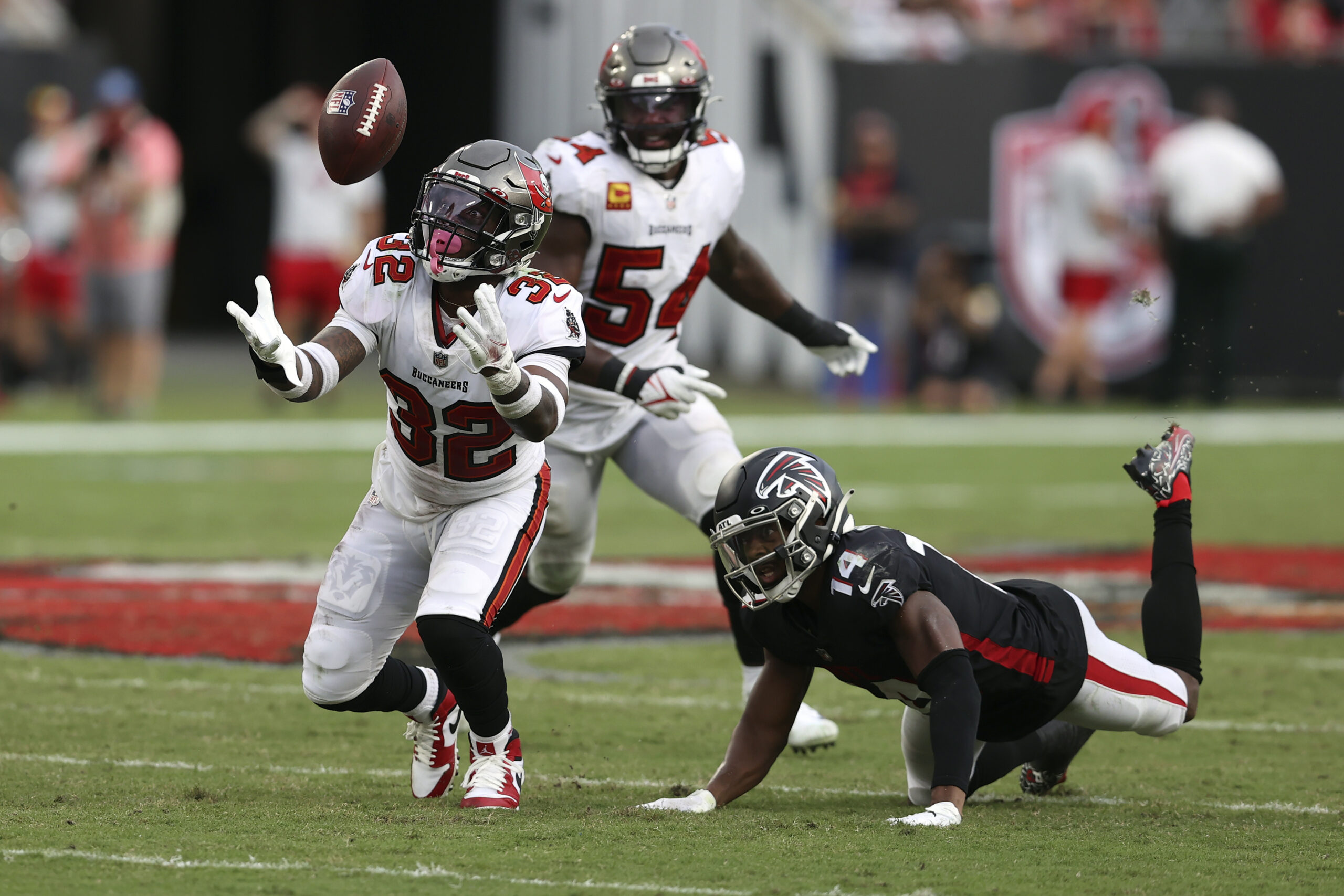 Tampa Bay Buccaneers safety Mike Edwards (32) intercepts a pass by Atlanta Falcons quarterback Matt Ryan that was intended for wide receiver Russell Gage (14) and returns it for a score during the second half of an NFL football game Sunday, Sept. 19, 2021, in Tampa, Fla. (AP Photo/Mark LoMoglio)