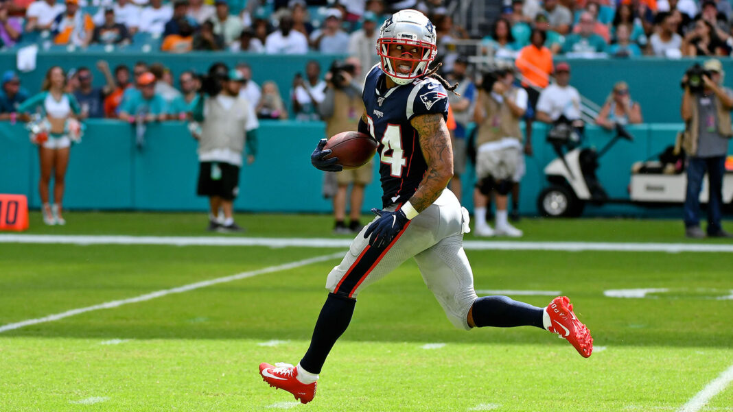 Sep 15, 2019; Miami Gardens, FL, USA; New England Patriots cornerback Stephon Gilmore (24) runs back an interception for a touchdown against the Miami Dolphins during the second half at Hard Rock Stadium. Mandatory Credit: Jasen Vinlove-USA TODAY Sports