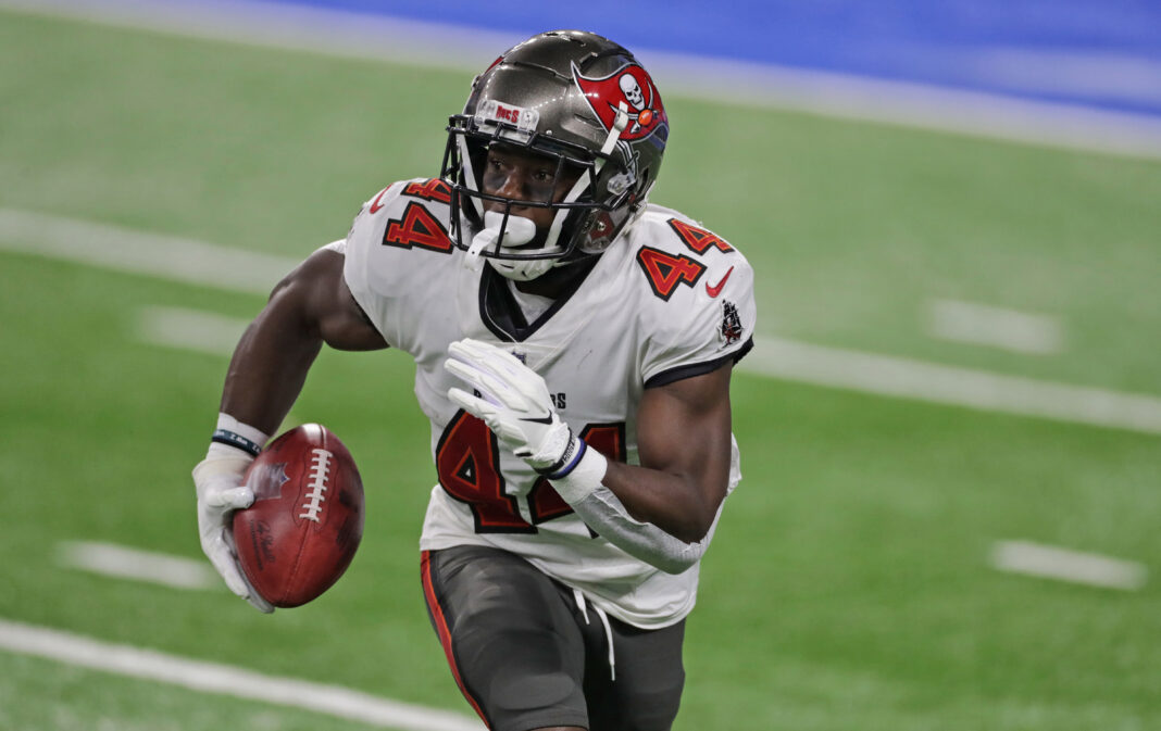 DETROIT, MICHIGAN - DECEMBER 26: Kenjon Barner #44 of the Tampa Bay Buccaneers returns a punt for a short gain during the second quarter of the game against the Detroit Lions at Ford Field on December 26, 2020 in Detroit, Michigan. Tampa defeated Detroit 47-7 (Photo by Leon Halip/Getty Images)