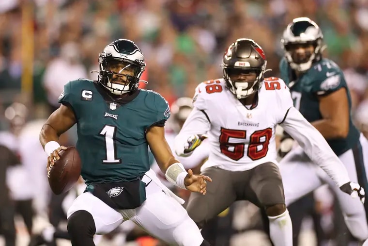 Eagles quarterback Jalen Hurts races past Tampa Bay Buccaneers outside linebacker Shaquil Barrett during the second quarter on Thursday, October 14, 2021 in Philadelphia.DAVID MAIALETTI / Staff Photographer