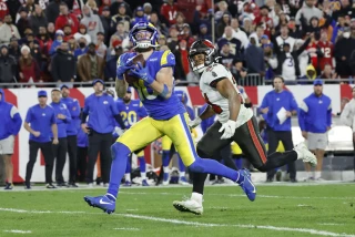 Rams wide receiver Cooper Kupp is tackled by Buccaneers safety Antoine Winfield Jr. after making a 44-yard catch to set up a game-winning field goal in the Rams’ 30-27 playoff win Sunday.(Robert Gauthier / Los Angeles Times)