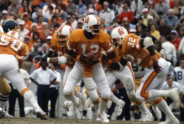Quarterback Doug Williams sporting the classic Buccaneers creamsicle uniforms against the Chargers on Dec. 13, 1981/Focus on Sport/Getty Images