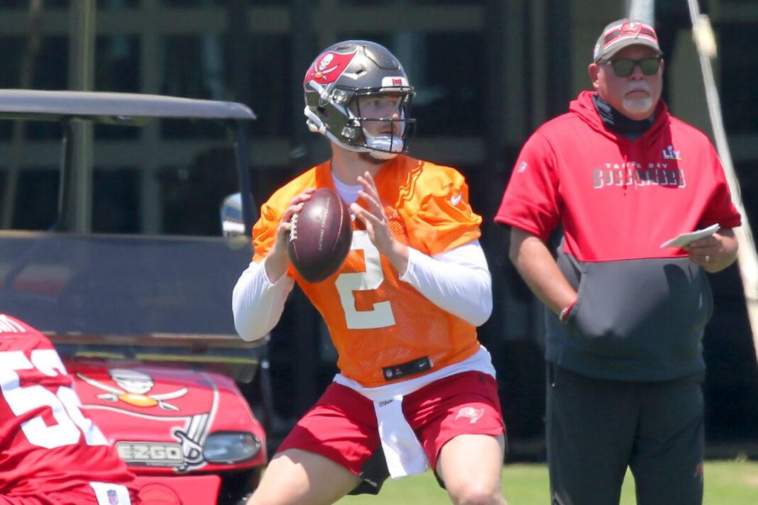 Buccaneers quarterback Kyle Trask throws during practice while head coach Bruce Arians looks on/via Welch/Icon Sportswire via Getty Images