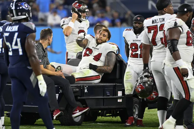 Buccaneers' offensive lineman Aaron Stinnie is carted off of the field against the Titans/via Associated Press