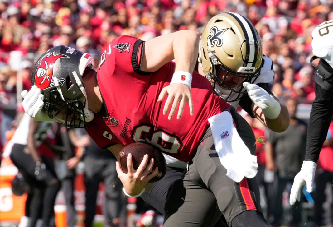 Tampa Bay Buccaneers quarterback Baker Mayfield is sacked by a New Orleans Saints defender / via neworleanssaints.com